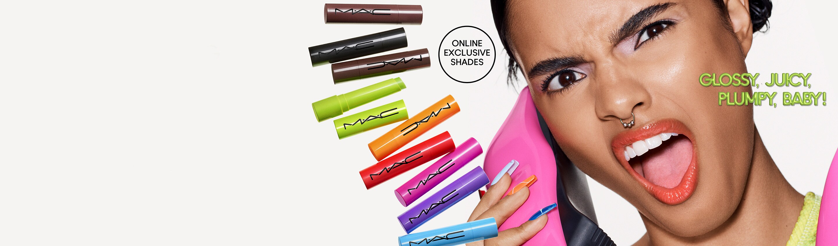 Group of lipsticks lying down on a grey background